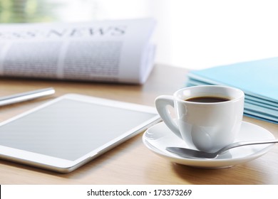 Business Office scene, digital tablet and newspaper with coffee  - Powered by Shutterstock