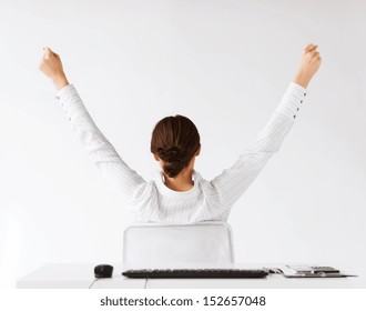 business, office, winning, achievement and education concept - woman from the back with raised hands