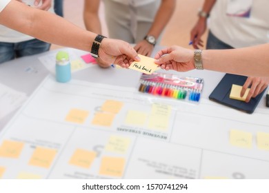 Business office worker handing the feedback note to his colleague after the presentation or when finish the project at the meeting board, discussion teamwork, creative idea, business idea concept. - Shutterstock ID 1570741294