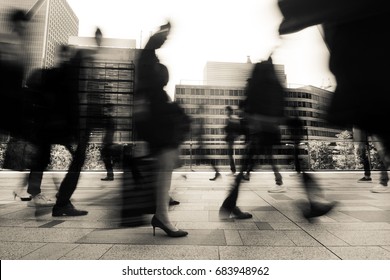 Business and office workers going to work in a fast blur during morning rush hour in Tokyo, Japan