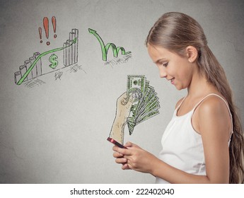 Business On A Go. Teenager Girl Working Online On Smart Phone Making Earning Money, Hand With Dollar Bills Banknotes Reward Coming Out Of Phone Screen Isolated Grey Background. Human Face Expression