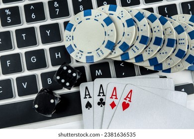 Business online poker games with laptop two black dice playing card and casino chips. Gambling concept - Powered by Shutterstock