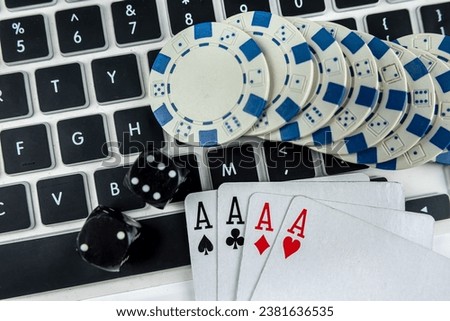 Business online poker games with laptop two black dice playing card and casino chips. Gambling concept