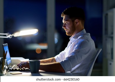 Business, Overwork, Deadline And People Concept - Man With Laptop And Coffee Working Late At Night In Office