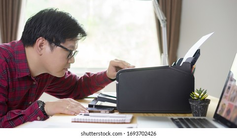 Business Owner Asian Man Using Printer For Business At Study Table In House,work From Home Concept 