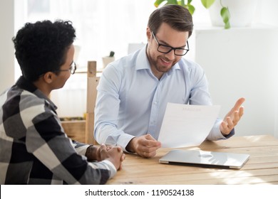 Business owner boss advisor interviewing new candidate black young woman vacancy company sitting at the desk in office. Boss smiling looking at resume, good first impression. HRs and hiring concept