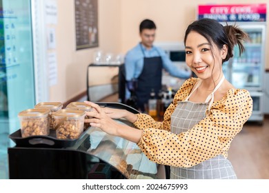 Business Owner. Cheerful Successful Female Small Business Owner Standing With A Smile. Customers At The Counter In A Coffee Shop Bakery And Convenience Store.