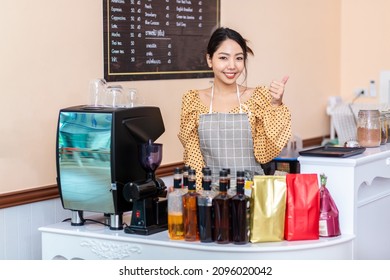 Business Owner. Cheerful Successful Female Small Business Owner Standing With A Smile. Customers At The Counter In A Coffee Shop Bakery And Convenience Store.