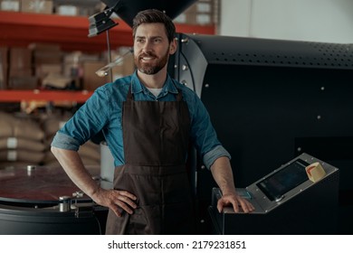 Business Owner Operating Of Coffee Roasting Machine On Small Roasted Factory And Looking Away