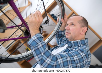 Business Owner Repairing Bicycle