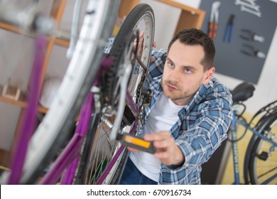 Business Owner Repairing Bicycle