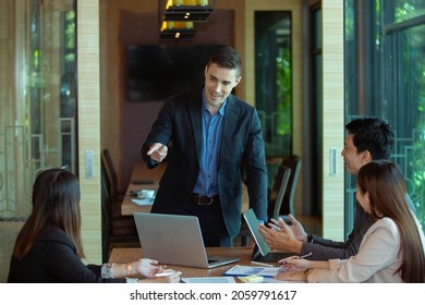 Business owners and employees in formal attire sit at a conference room table and argue about a company development project during the meeting. - Shutterstock ID 2059791617