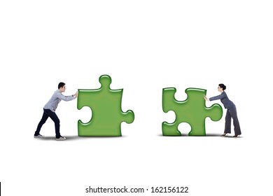 Business Partner Putting Together Two Puzzle Pieces - Isolated On White Background