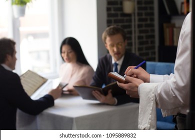 Business partners choosing dishes from menu at luxury restaurant. Waiter taking order. - Powered by Shutterstock