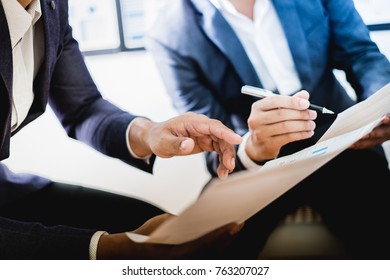 Business partners discussing documents and ideas at meeting - Shutterstock ID 763207027