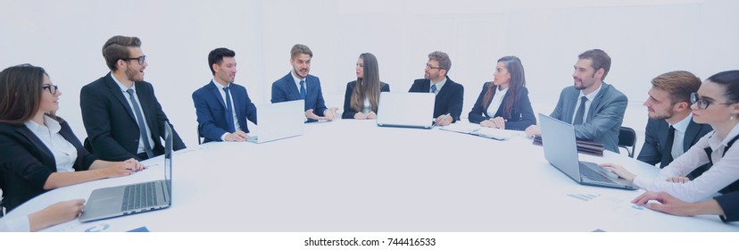 Business Partners Gathered Round A Table And Discuss The Finances