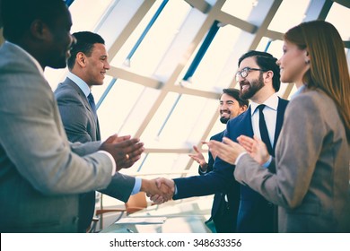 Business partners greeting each other after signing contract - Shutterstock ID 348633356