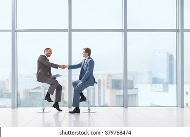 Business Partners Handshake In Office
