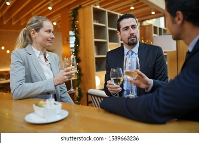 Business Partners Having A Drink At Hotel Bar