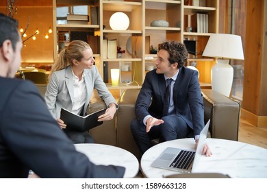 Business partners meeting client in hotel lounge - Powered by Shutterstock - Get 15% off with code: PIKWIZARD15