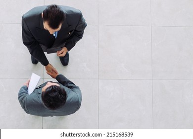 Business Partners Shaking Hands As A Symbol Of Unity, View From The Top