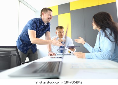 Business Partners Sit At Table And Discuss Workflow. Small And Medium Business Development Concept