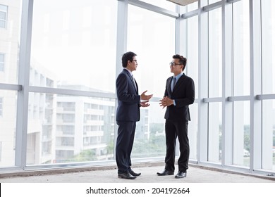 Business partners talking inside the building under construction - Powered by Shutterstock