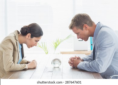 Business Partners Watching Crystal Ball In An Office