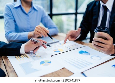 business partnership coworkers analysis strategy with discussing a financial planning graph and company budget during a budget meeting in office room. - Powered by Shutterstock