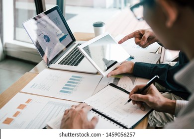 Business partnership coworkers using a tablet to analysis graph company financial budget report and cost work progress and planning for future in office room. - Shutterstock ID 1459056257