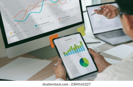 Business partnership coworkers using a tablet to analysis graph  financial budget report and planning for future in office desk - Powered by Shutterstock