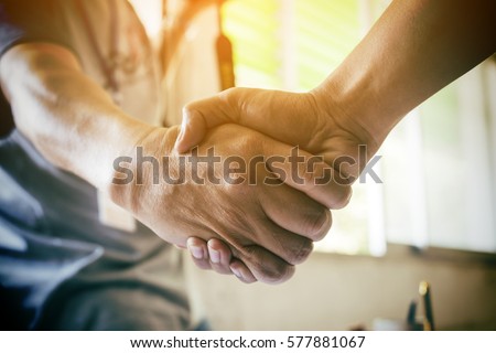 Business partnership meeting concept. Image businessman handshake. Successful businessmen handshaking after good deal. Horizontal, blurred background