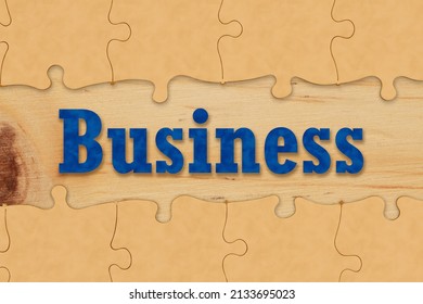 Business Partnership And Teamwork Concept Coming Together With Puzzle Pieces On A Wood Desk