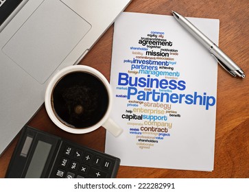 "BUSINESS PARTNERSHIP word cloud arrangement" Notebook with text vision on table with coffee, calculator and notebook