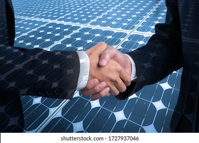 Business, Partnership,Cooperation and gesture concept - businesswoman and architecture shaking hands over Solar energy panel photovoltaics module double exposure background