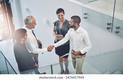 Business people, above or handshake in agreement for greeting, meeting or partnership. Collaboration, thank you or mature boss with man for B2B support, introduction or deal for recruitment in office - Powered by Shutterstock