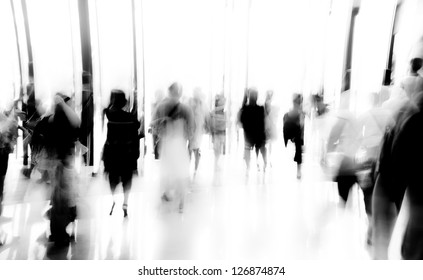 business people activity standing and walking in the lobby motion blurred black and white