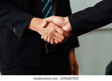 Business people agreement concept. Businessman do handshake with another businessman in the office meeting room. uds - Shutterstock ID 2396387433