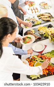 Business People Around Buffet Table Catering Food At Company Event