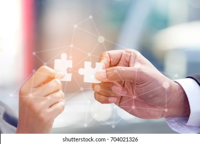 Business People Assembling Jigsaw Puzzle and Present Teamwork Support in Office with Digital Layer Business Strategy and Social Media Diagram, 
Partnership Sale Team 
 Collaborate With Competitors  - Shutterstock ID 704021326