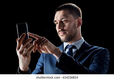 business, people, augmented reality and modern technology concept - businessman in suit working with transparent smartphone over black background - Powered by Shutterstock