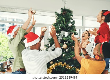 Business people, bauble and christmas tree with applause for celebration, decor or new year at office. Young, group or employees decorating with ornament for December holiday or surprise at workplace - Powered by Shutterstock