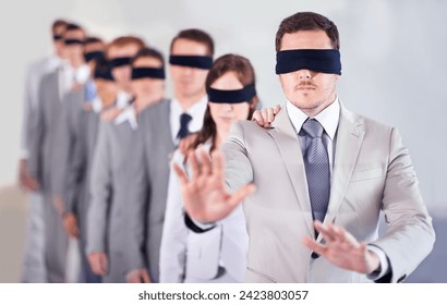 Business people, blindfold and leader in office, team and solidarity in workplace. Challenge, employees and collaboration in uncertainty, control strategy and support in searching or workforce - Powered by Shutterstock