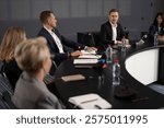 Business people at boardroom meet in modern international center. Microphone speech of Caucasian man as economy expert at conference forum. Presentation group works at debate indoor in convention hall