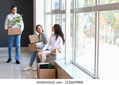 Business people with boxes in office on moving day - Powered by Shutterstock