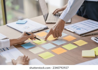 Business People brainstorming Meeting Design Ideas use post it notes to share idea professional investor start up project business brainstorming planning in office. - Powered by Shutterstock