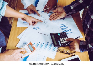 Business people brainstorming at office desk, they are analyzing financial reports and pointing out financial data on a sheet
 - Shutterstock ID 620325089