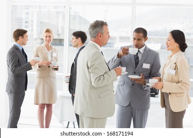 Business People Chatting And Drinking Coffee At A Conference In The Office