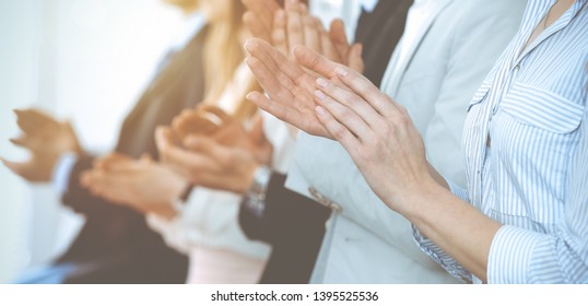 Business people clapping and applause at meeting or conference, close-up of hands. Group of unknown businessmen and women in modern white office. Success teamwork or corporate coaching concept - Shutterstock ID 1395525536
