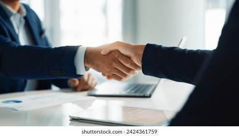 Business people, closeup and handshake for deal, agreement and partnership negotiation in office. Shaking hands, contract and hiring offer for recruitment, interview and financial analyst in meeting - Powered by Shutterstock